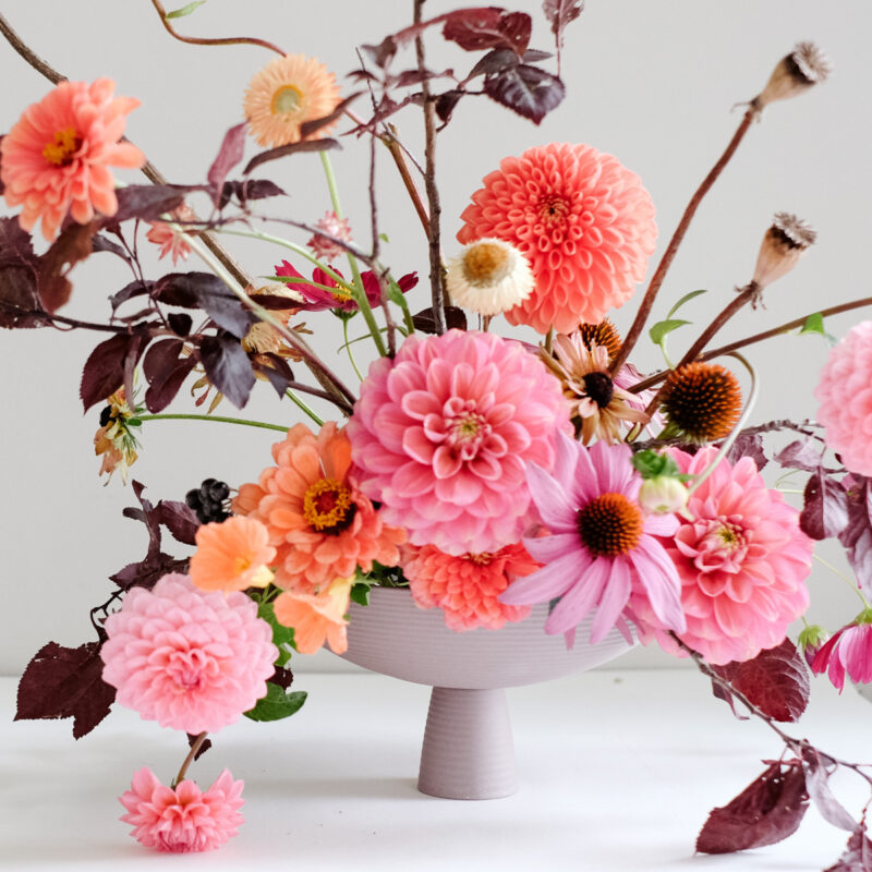 Blumenarragement in Bowl mit Dahlien, Zinnien in Pink und Orange herbstlich